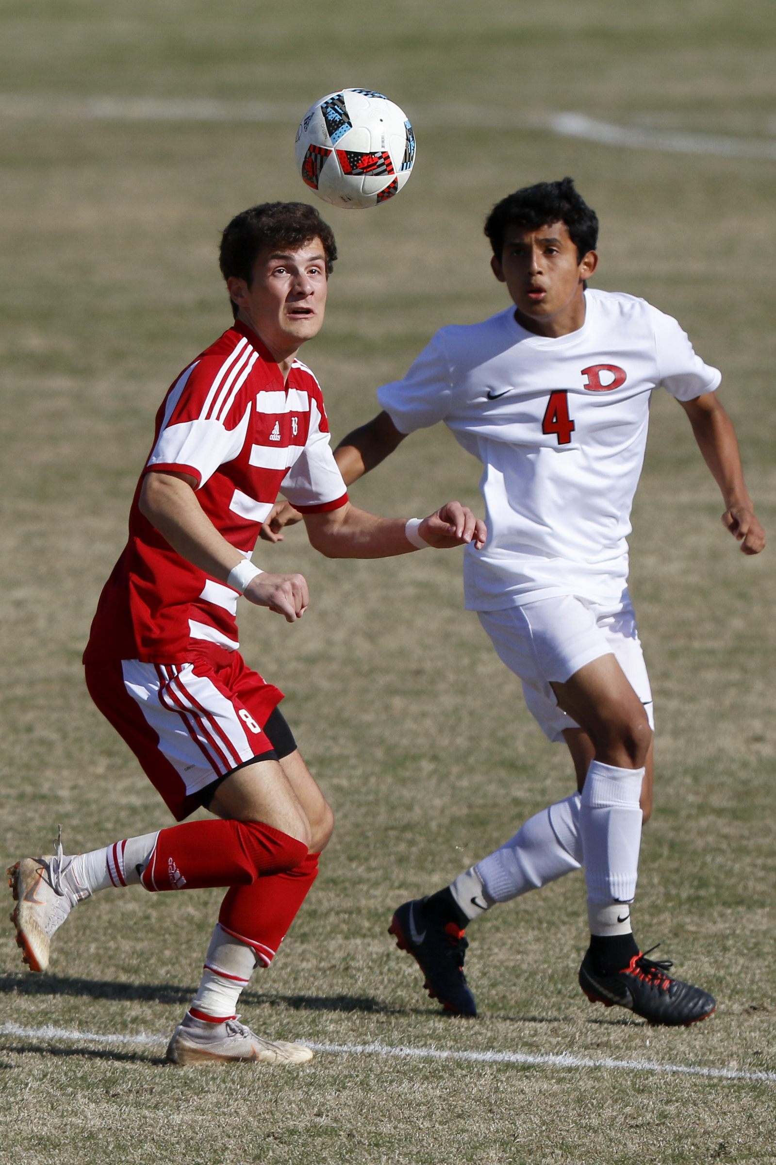 Baylor's John Musick (8) eyes the ball against Uriel Mendoza (4) and Dalton at Baylor School on Tuesday, April 2, 2019 in Chattanooga, Tenn.