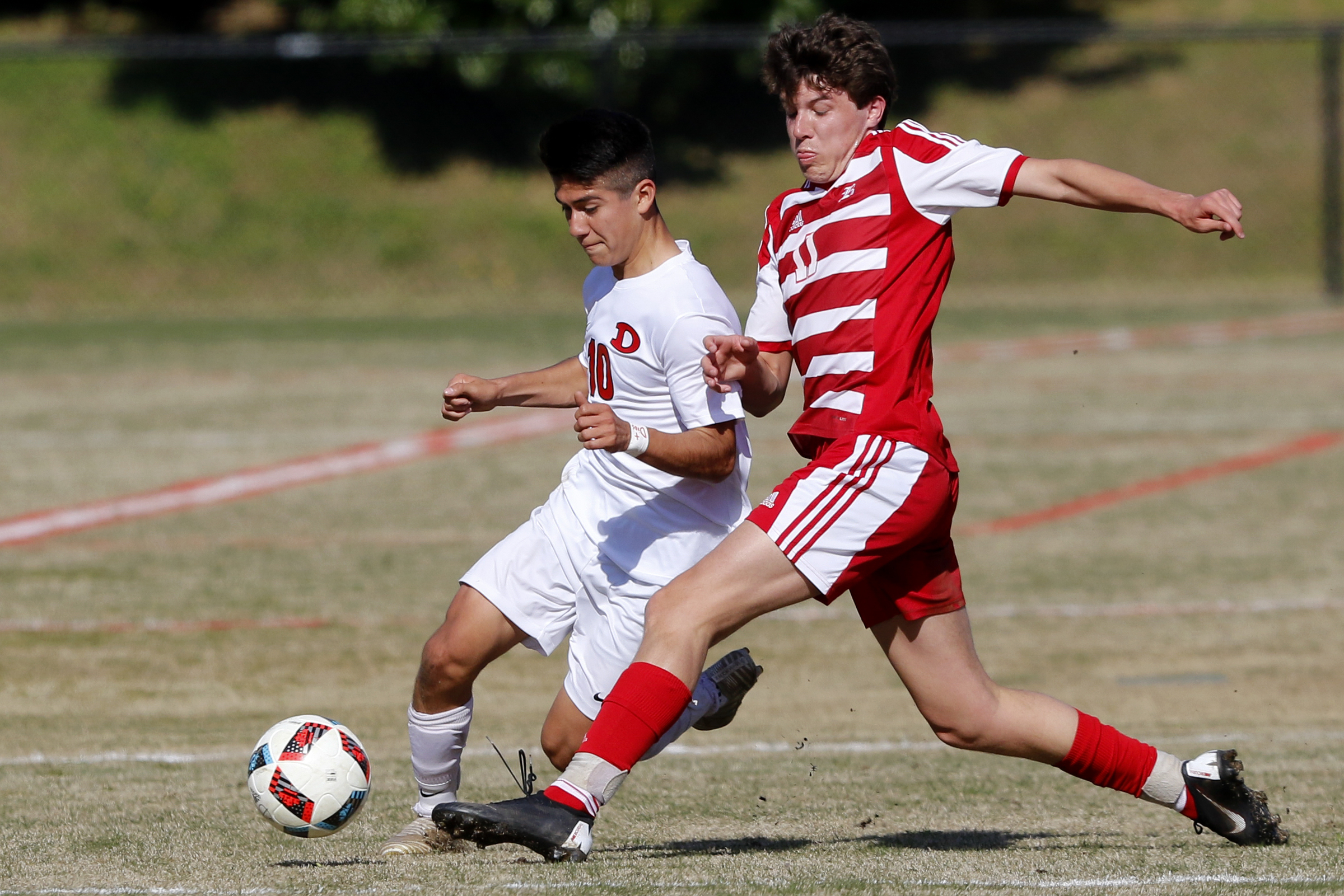 Baylor's Carter Smith (11) clears the ball away from Dalton's Manny Prieto (10) at Baylor School on Tuesday, April 2, 2019 in Chattanooga, Tenn.