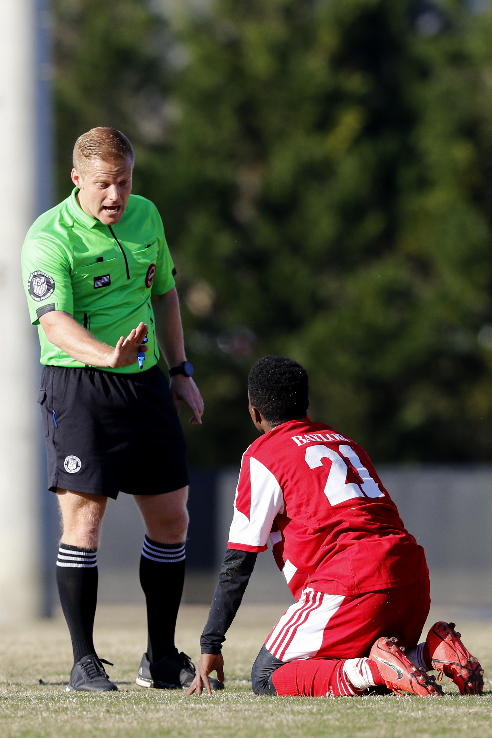 The referee tells Baylor's David Danquah (21) to stop diving during a game against Dalton at Baylor School on Tuesday, April 2, 2019 in Chattanooga, Tenn.