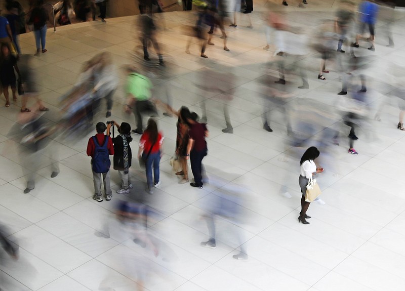 FILE- In this June 15, 2017, file photo, people walk inside the Oculus, the new transit station at the World Trade Center in New York. Getting your credit score today is easy, just turn to your bank, credit card issuer or one of the many apps and websites out there. That means millennials, unlike their parents, have the advantage of early insight into their financial profiles. (AP Photo/Frank Franklin II, File)