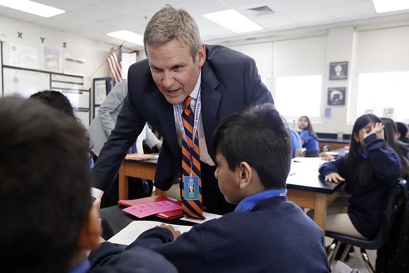 Tennessee Gov. Bill Lee talks with students during a visit to Cameron Middle School Monday, April 1, 2019, in Nashville, Tenn. (AP Photo/Mark Humphrey)