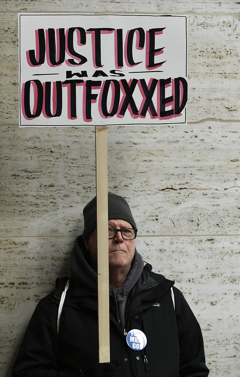 Protester Mike Moster of Chicago holds a sign while protesting Cook County State's Attorney Kim Foxx's office's decision to drop all charges against "Empire" actor Jussie Smollett on April 1 in Chicago. (AP Photo/Paul Beaty)