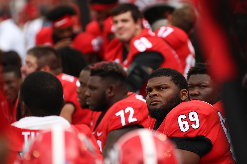 Georgia offensive lineman Jamaree Salyer (69) looks up at the Sanford Stadium scoreboard during last September's 49-7 win over Middle Tennessee State.