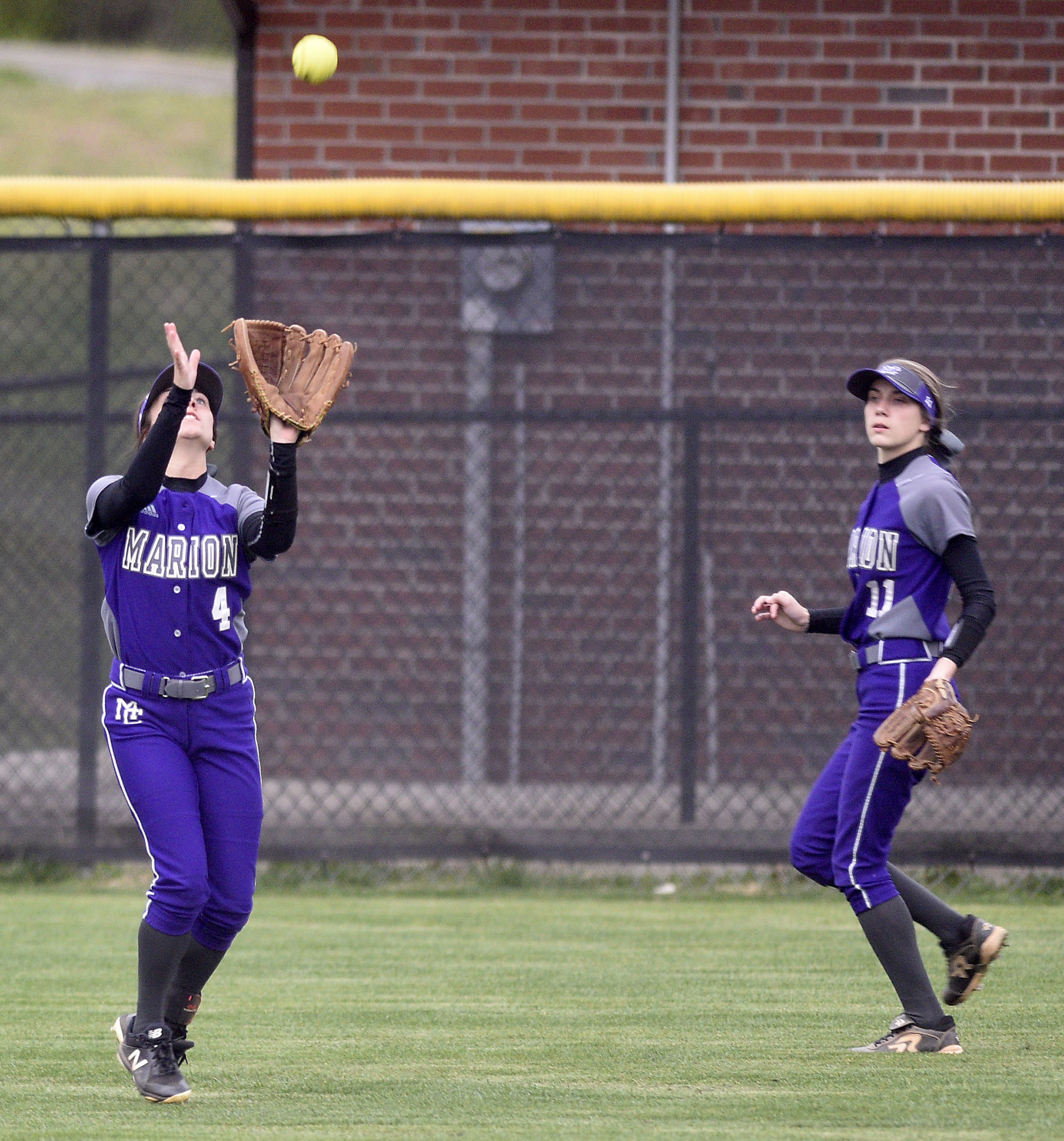 Marion centerfielder Savannah Parker (4) pulls in fly ball while rightfielder Audrey Schaefer (11) looks on, The Marion County High Lady Warriors visited the Sequatchie County Lady Indians in TSSAA softball action on April 4, 2019.