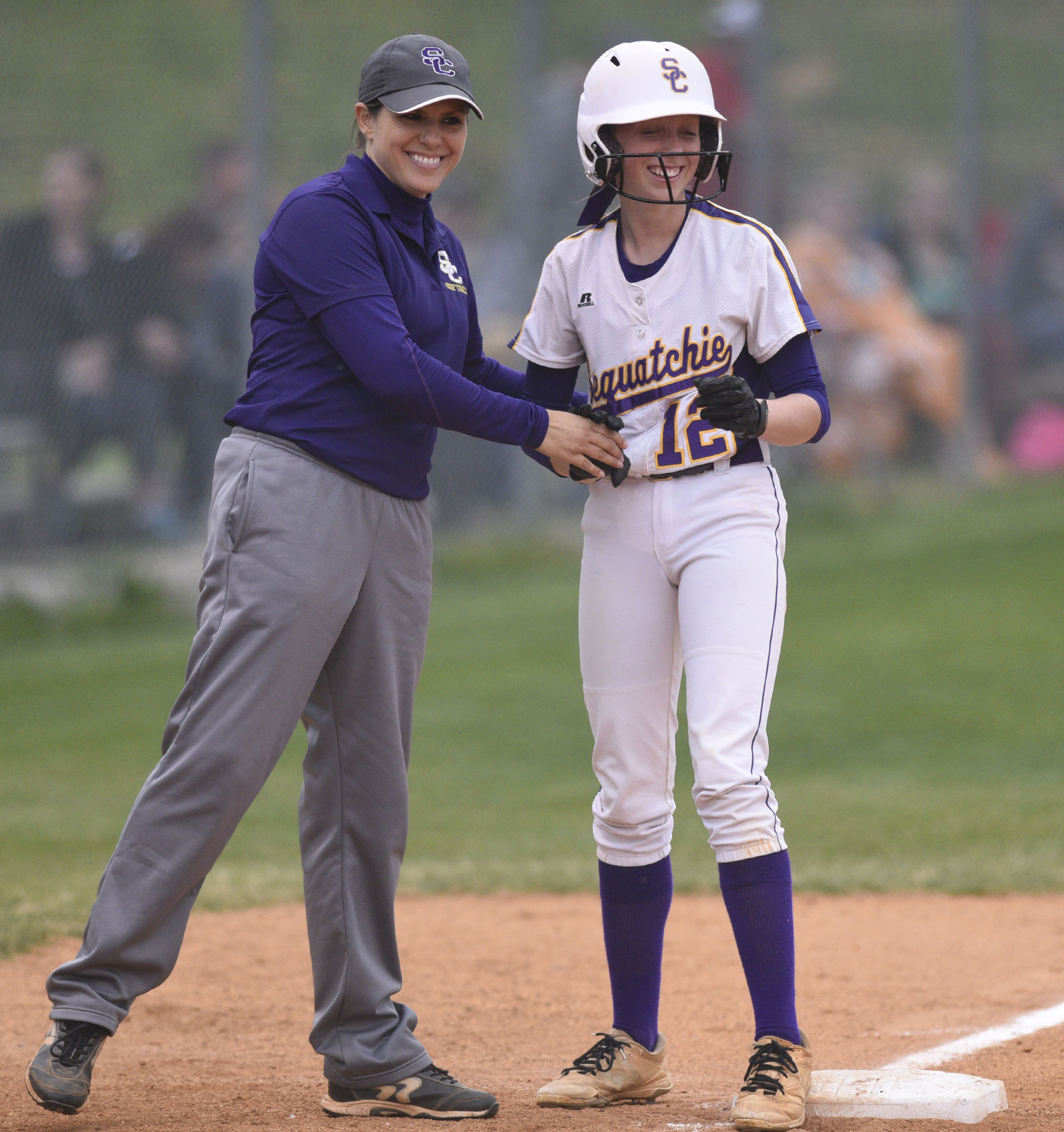 Sequatchie head coach Kelly Somerville congratulates Addy Edgmon (12) on reaching third. The Marion County High Lady Warriors visited the Sequatchie County Lady Indians in TSSAA softball action on April 4, 2019.