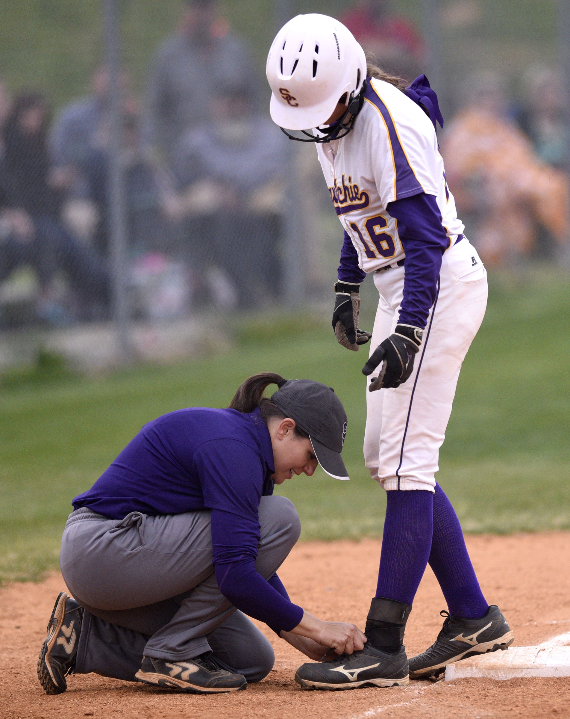 Sequatchie head coach Kelly Somerville ties Jesyca Dennis's shoe on third base. The Marion County High Lady Warriors visited the Sequatchie County Lady Indians in TSSAA softball action on April 4, 2019.