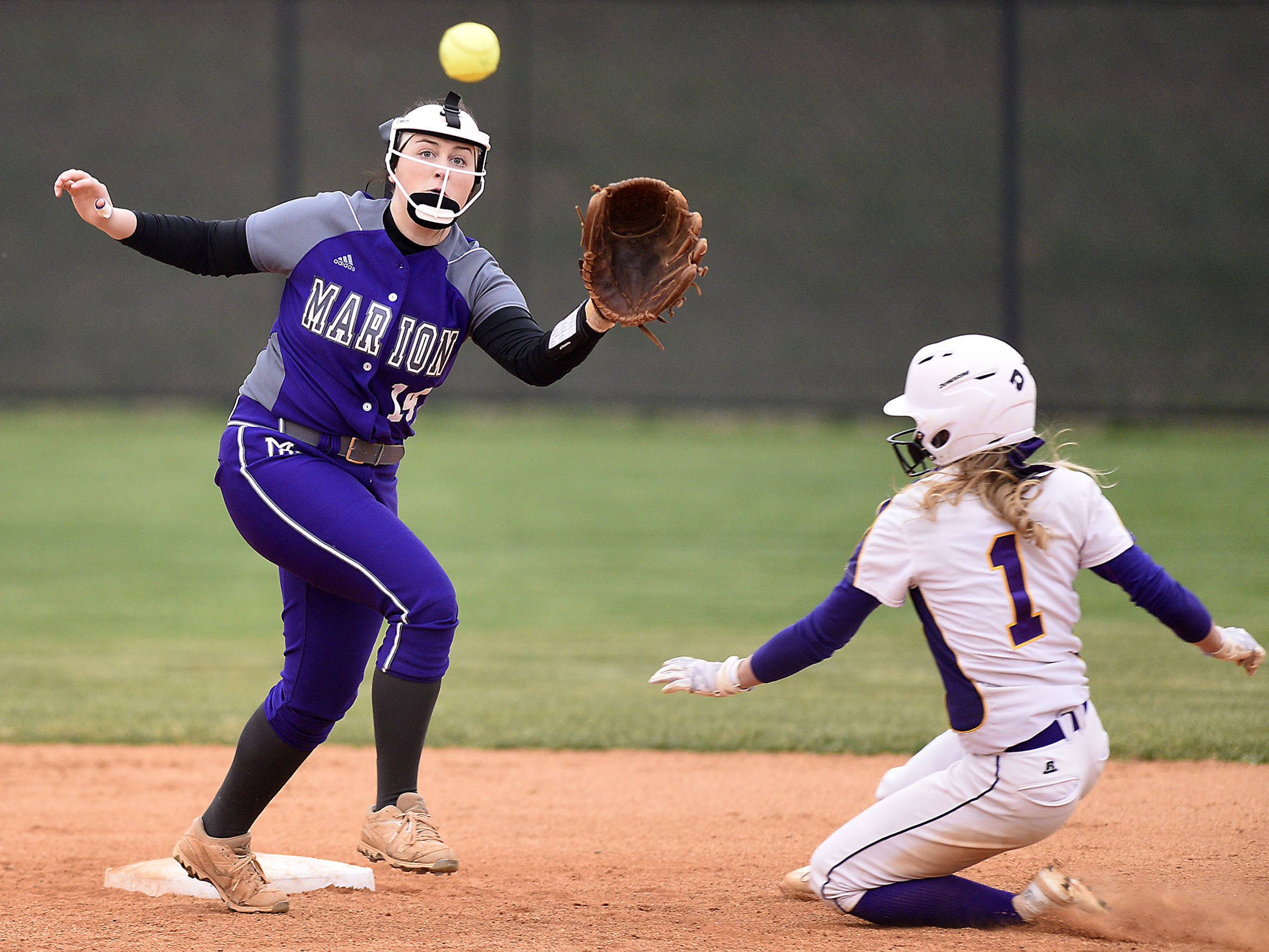 Sequatchie's Ella Edgmon (1) slides safely into second as Marion shortstop Teja Jordan (14) takes the throw. The Marion County High Lady Warriors visited the Sequatchie County Lady Indians in TSSAA softball action on April 4, 2019.