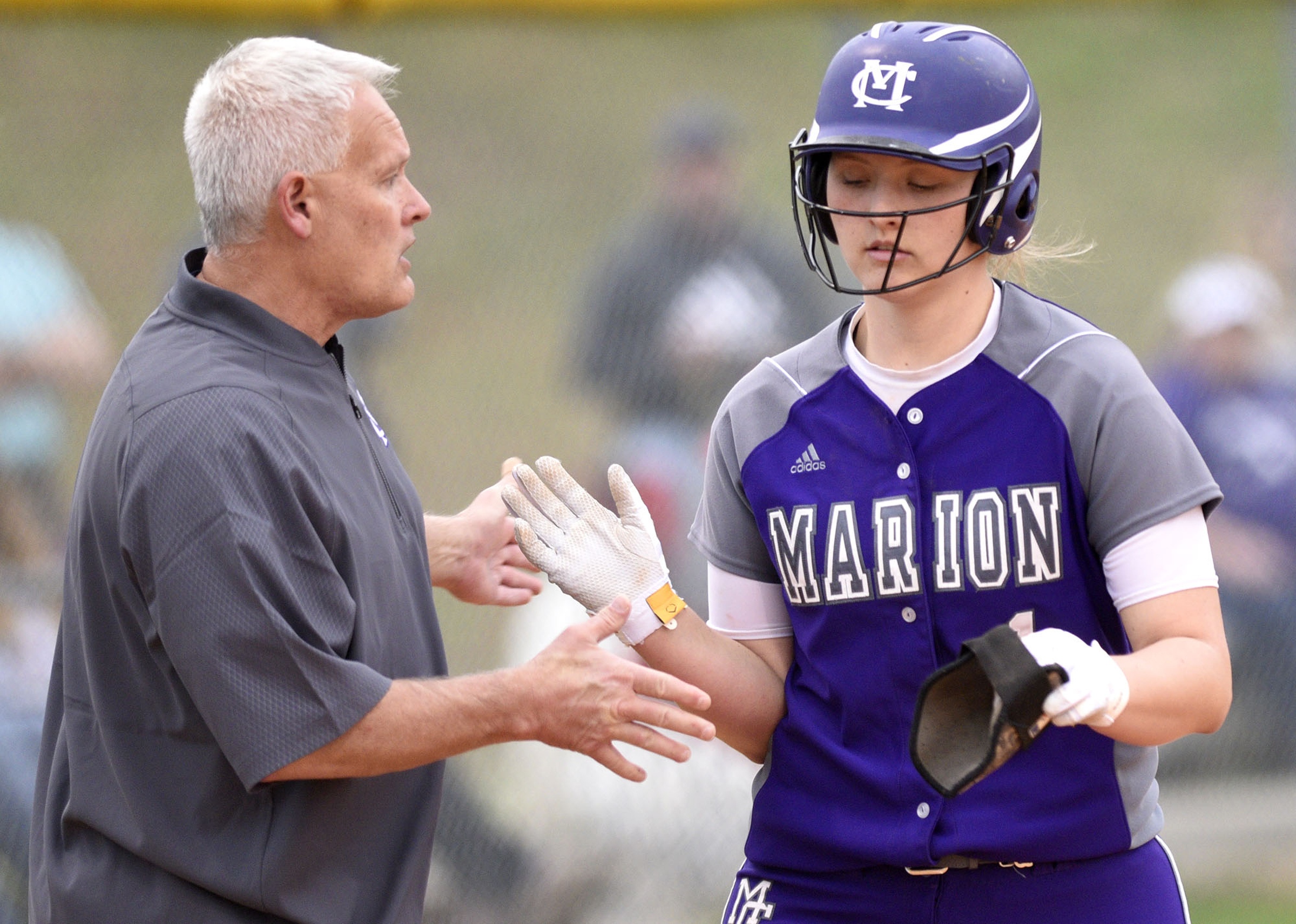 Marion's Sara Muir (1) is congratulated after a home runs by head coach, Randy Ellis. The Marion County High Lady Warriors visited the Sequatchie County Lady Indians in TSSAA softball action on April 4, 2019.