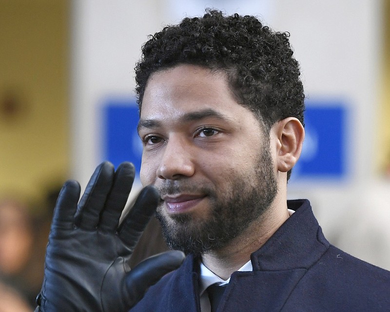 FILE - In this March 26, 2019, file photo, actor Jussie Smollett smiles and waves to supporters before leaving Cook County Court after his charges were dropped in Chicago. A deadline is looming for Smollett to pay over $130,000 to Chicago to cover part of the costs of an investigation into his report of a racist, anti-gay attack or risk getting slapped with a civil lawsuit. Thursday, April 4, is seven days since Mayor Rahm Emanuel's law department sent the "Empire" a March 28 letter demanding he writes them a money order or cashier's check for $130,106, plus 15 cents. It said he had seven days. (AP Photo/Paul Beaty, File)

