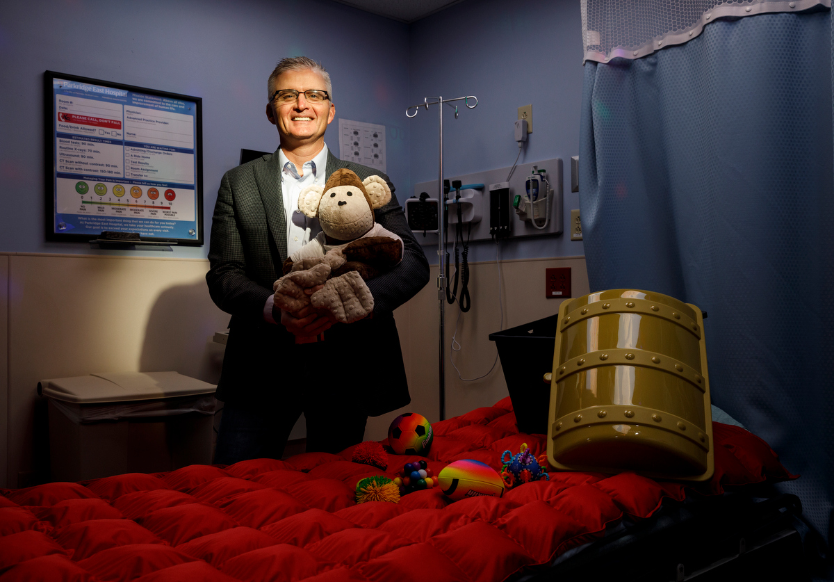 Emergency Department Medical Director Dr. Ben Cottrell holds a weighted monkey as he poses for a portrait in a new sensory-friendly exam room in the emergency room at Parkridge East on Thursday, April 4, 2019, in Chattanooga, Tenn. The room includes special features like sound-proofing, calming lighting and a weighted blanket to accommodate patients with autism and sensory sensitivity.