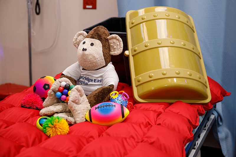 A weighted monkey, weighted blanket and toys are displayed in a new sensory-friendly exam room in the emergency room at Parkridge East on Thursday, April 4, 2019, in Chattanooga, Tenn. The room includes special features like sound-proofing, calming lighting and a weighted blanket to accommodate patients with autism and sensory sensitivity.