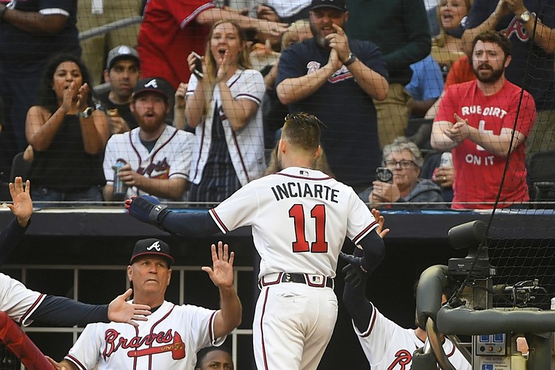 AP photo / The Atlanta Braves' Ender Inciarte enters the dugout after scoring on a Freddie Freeman double to right field during the first inning of the team's game against the Miami Marlins on April 7, 2019, in Atlanta.