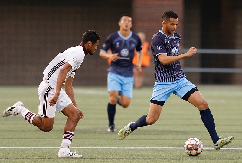 CFC's Jowayne Laidley dribbles out ahead of Detroit's Willie Spurr during Chattanooga FC's soccer match against Detroit City FC at Finley Stadium on Saturday, April 6, 2019, in Chattanooga, Tenn. 