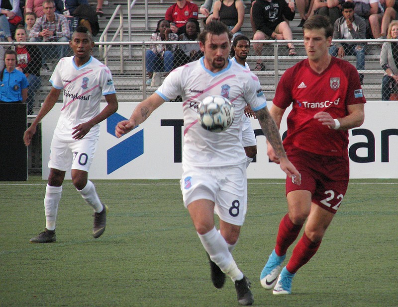 Chattanooga Red Wolves SC midfielder Conor Doyle, right, goes against Forward Madison FC's Jeff Michaud during Saturday night's game at Chattanooga Christian School. The Red Wolves won 1-0 for their first USL League One victory.