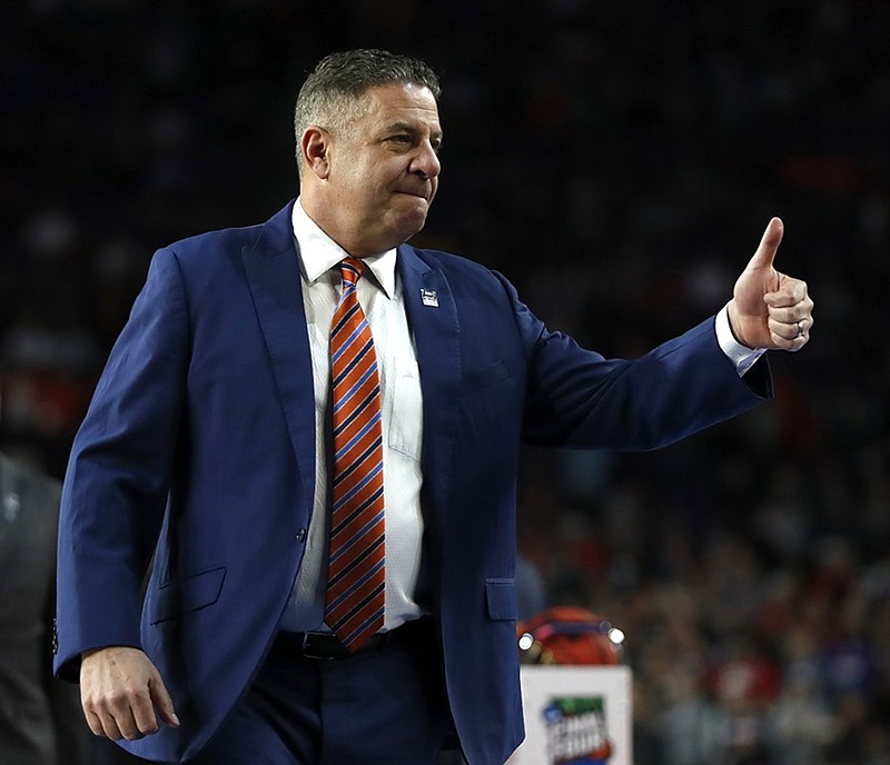 Auburn men's basketball coach Bruce Pearl gives a thumb's up to fans before the Tigers' national semifinal against Virginia at the Final Four on Saturday night in Minneapolis.