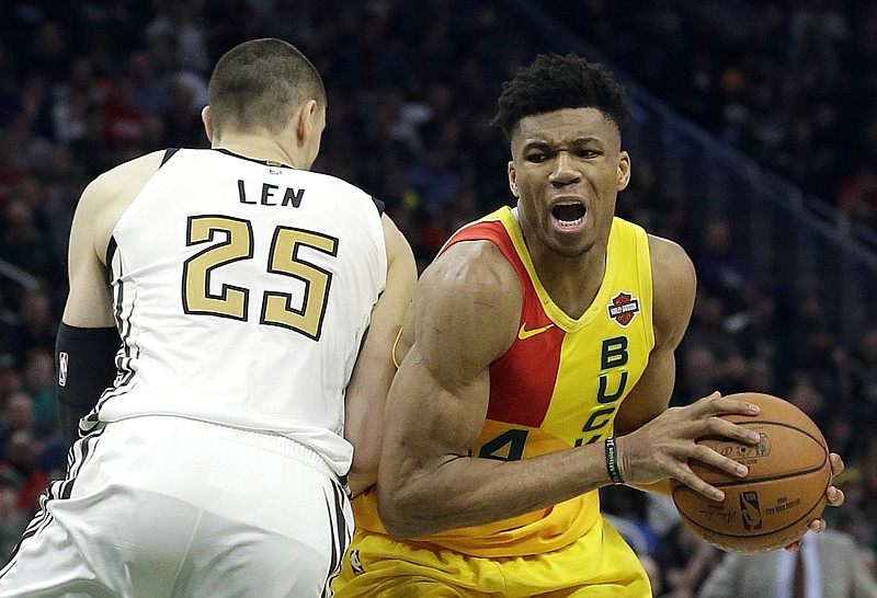 The Milwaukee Bucks' Giannis Antetokounmpo drives to the basket against the Atlanta Hawks' Alex Len during the second half of Sunday's game in Milwaukee.