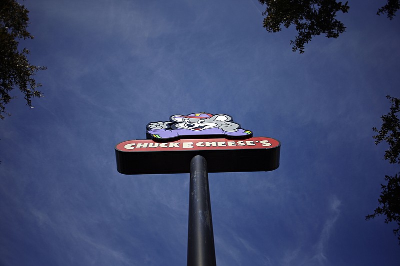 FILE- This Jan. 16, 2014, file photo shows a sign outside a Chuck E. Cheese's location in Dallas. Chuck E. Cheese is returning to the public markets. CEC Entertainment Inc., which owns 750 Chuck E. Cheese and Peter Piper Pizza stores in the U.S. and abroad, expects to begin trading on the New York Stock Exchange in the second quarter. (G.J. McCarthy/The Dallas Morning News via AP, File)