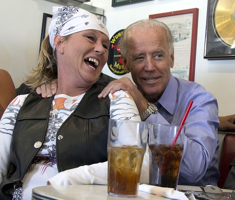 Then-Vice President Joe Biden campaigns for re-election in 2012 with a biker over lunch at Cruisers Diner in Seaman, Ohio.