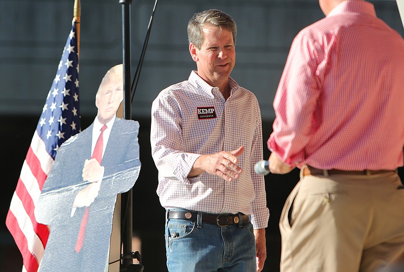 Staff filephoto by Erin O. Smith / Tennessee Secretary of State Tre Hargett, right, shakes hands last July with then-Georgia gubernatorial candidate Brian Kemp during a Georgia campaign stop at the Burr Performing Arts Park in Dalton.