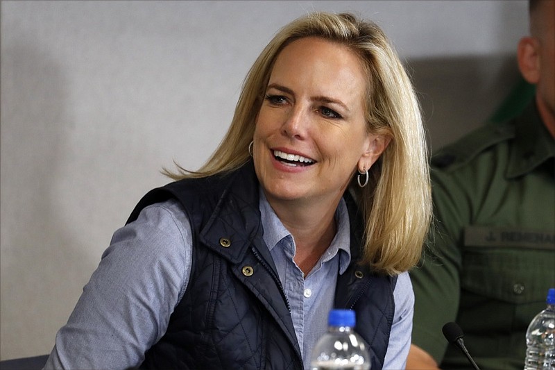 Homeland Security Secretary Kirstjen Nielsen listens to President Donald Trump at a roundtable on immigration and border security at the U.S. Border Patrol Calexico Station in Calexico, Calif., Friday April 5, 2019. Trump headed to the border with Mexico to make a renewed push for border security as a central campaign issue for his 2020 re-election. (AP Photo/Jacquelyn Martin)