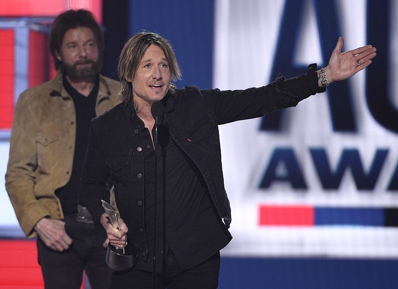 Keith Urban, right, accepts the award for entertainer of the year as presenter Ronnie Dunn, of Brooks & Dunn, looks on at the 54th annual Academy of Country Music Awards at the MGM Grand Garden Arena on Sunday, April 7, 2019, in Las Vegas. (Photo by Chris Pizzello/Invision/AP)