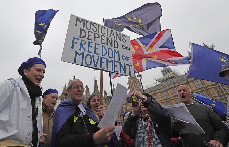 Pro EU protestors and singers of a choir perform opposite the Houses of Parliament in London, Monday, April 8, 2019. Britain's government and opposition parties are clinging to hope Monday of finding a compromise Brexit deal.(AP Photo/Frank Augstein)