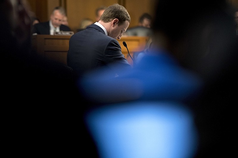 FILE- In this April 10, 2018, file photo Facebook CEO Mark Zuckerberg pages while testifying before a joint hearing of the Commerce and Judiciary Committees on Capitol Hill in Washington. Momentum is gaining in Washington for a privacy law that would sharply reduce the ability of the largest technology companies to collect and distribute people's personal data. Zuckerberg, published a column last month in the Washington Post calling for tighter regulations to protect consumer data, control harmful content and ensure election integrity and data portability. (AP Photo/Andrew Harnik, File)

