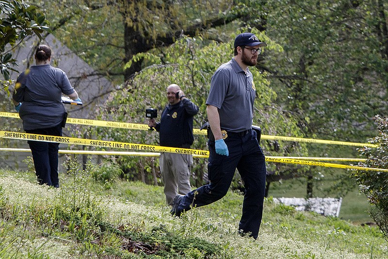 Staff photo by C.B. Schmelter / 
A Tennessee Bureau of Investigation agent works at the scene of a shooting on the 9100 block of Broyles Drive on Tuesday, April 9, 2019 in Chattanooga, Tenn.