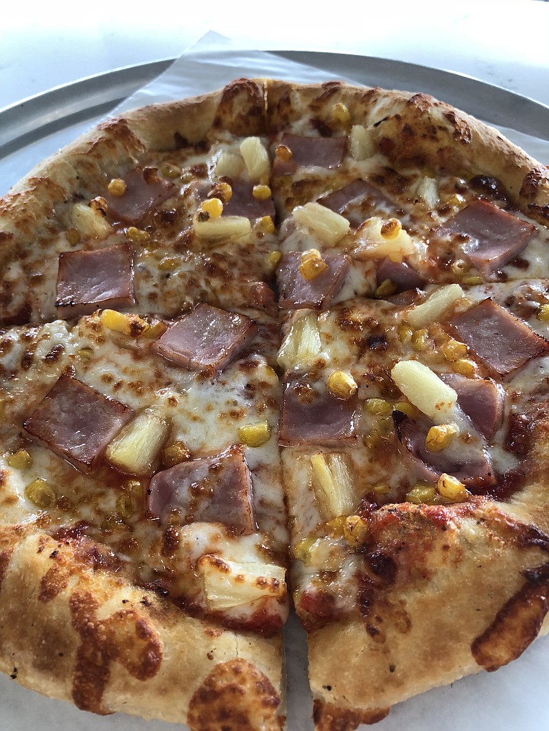 Hawaiian pizza at Dida's is layered in ham squares, pineapple and sweet corn kernels.