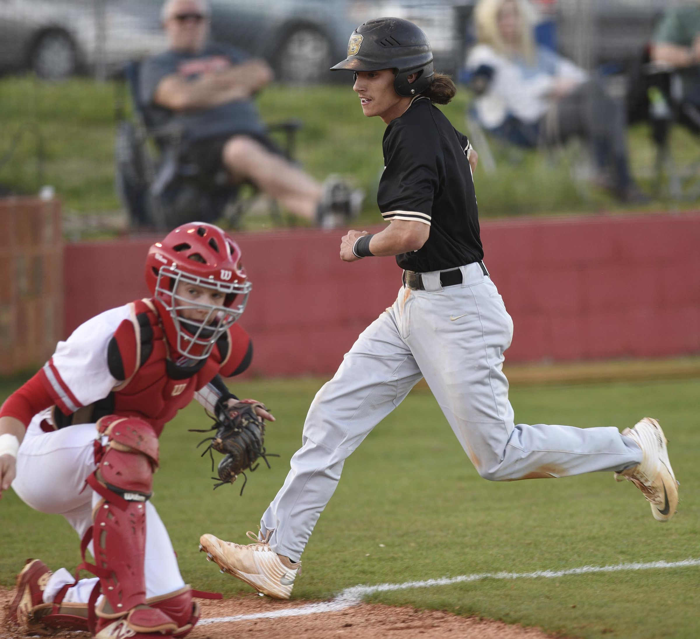 Bradley's Ryan Giovengo (1) comes home during a rundown while the throw gets by Ooltewah catcher Eli Wells (1). This was Bradley's first score. The Bradley Central Bears visited the Ooltewah Owls in TSSAA baseball action on April 9, 2019.