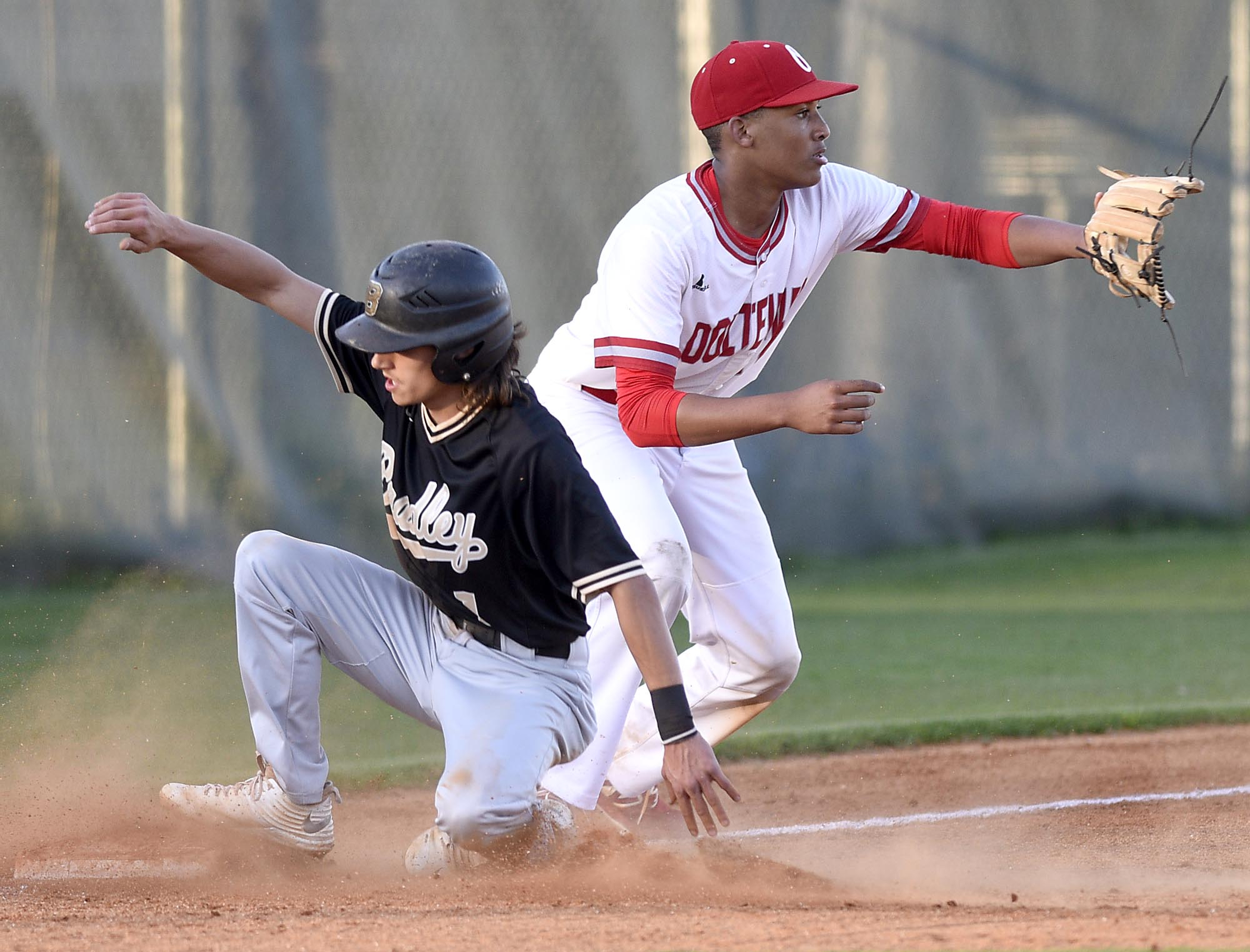 Bradley's Ryan Giovengo (1) is safe at third as Ooltwah's Kael Williams (17) waits for the throws. The Bradley Central Bears visited the Ooltewah Owls in TSSAA baseball action on April 9, 2019.