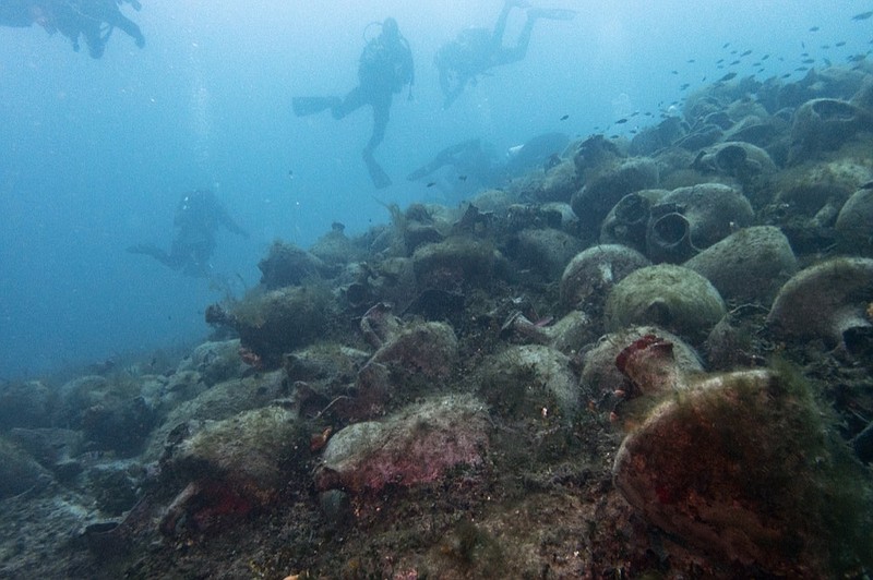 In this photo taken on Sunday, April 7, 2019, divers visit a 5th Century B.C. shipwreck, the first ancient shipwreck to be opened to the public in Greece, including to recreational divers who will be able to visit the wreck itself, near the coast of Peristera, Greece. Greece's rich underwater heritage has long been hidden from view, off-limits to all but a select few, mainly archaeologists. Scuba diving was banned throughout the country except in a few specific locations until 2005, for fear that divers might loot the countless antiquities that still lie scattered on the country's seabed. Now that seems to be gradually changing, with a new project to create underwater museums. (AP Photo/Elena Becatoros)

