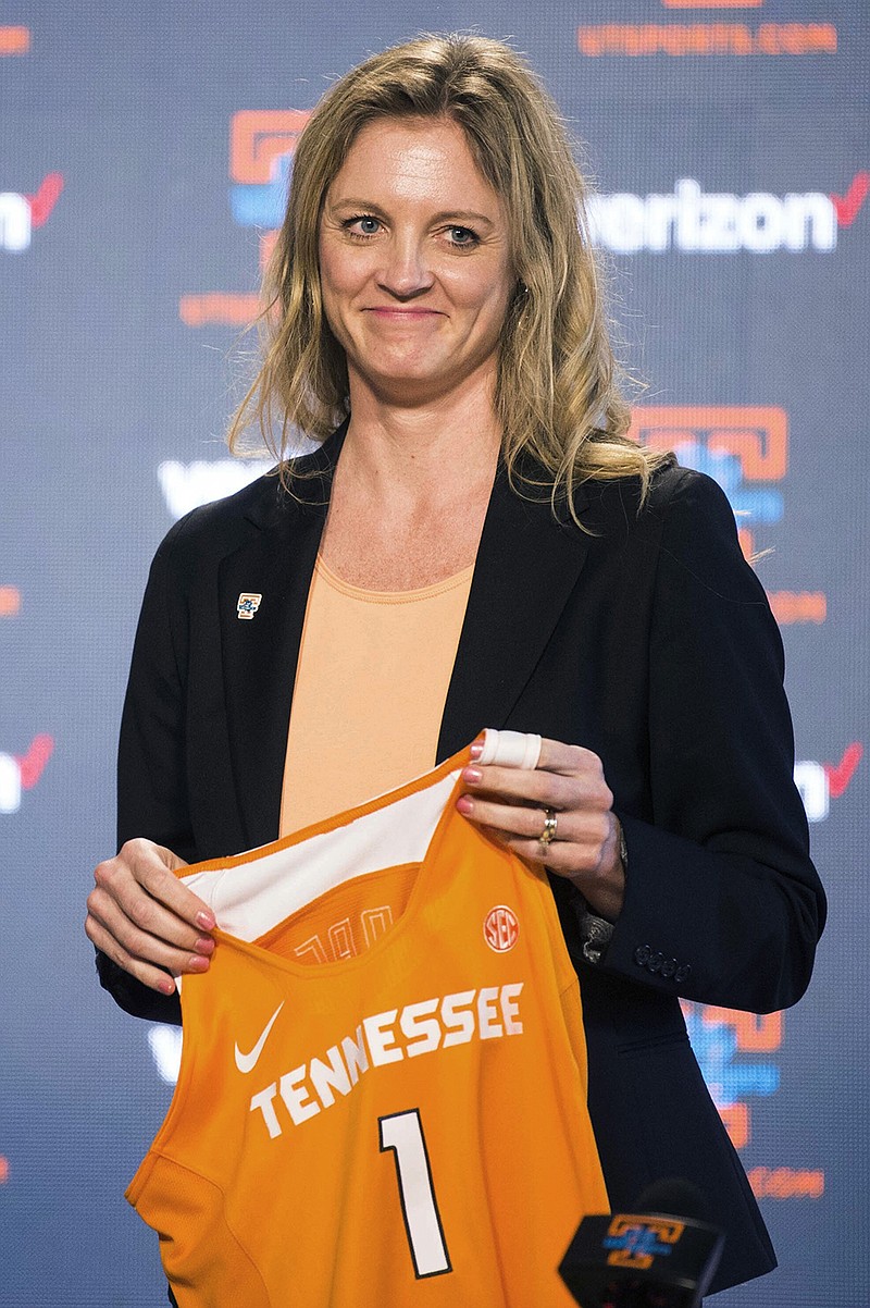 Former Tennessee basketball player Kellie Harper holds a jersey during Wednesday's news conference introducing her as coach of the Lady Vols.