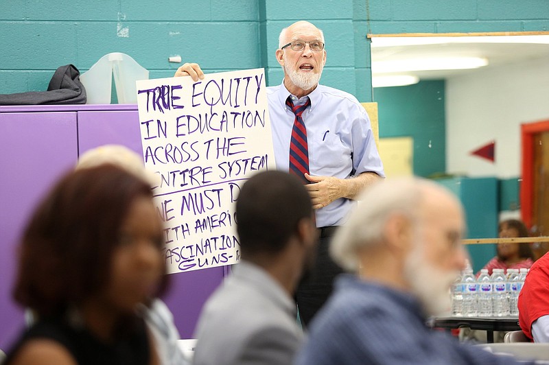 Franklin McCallie reads off ideas his group came up with for approaches and programs to help stop gun violence at the Cost of the Crossfire forum hosted by the Chattanooga Times Free Press Wednesday, April 10, 2019 at the Carver Youth and Family Development Center in Chattanooga, Tennessee. 