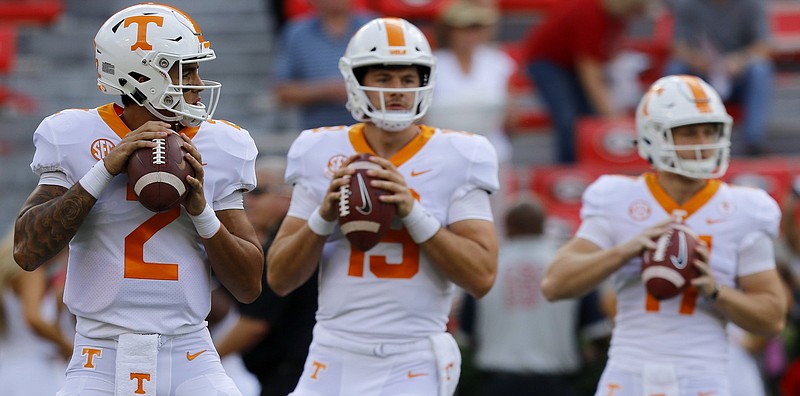 From left, quarterbacks Jarrett Guarantano (2), Keller Chryst (19) and Will McBride (17) warm up before Tennessee's game at Georgia last September. Guarantano is the only one of the three still with the Vols. Chryst was a graduate transfer and McBride has transferred out.