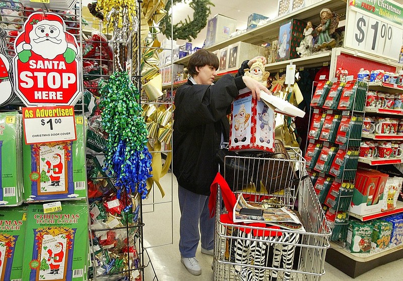 In this 2002 file photo, Mirenda Creasy, of Westmoreland, Tenn., looks for holiday bargains at Fred's discount store in Portland, Tenn. (AP Photo/John Russell)