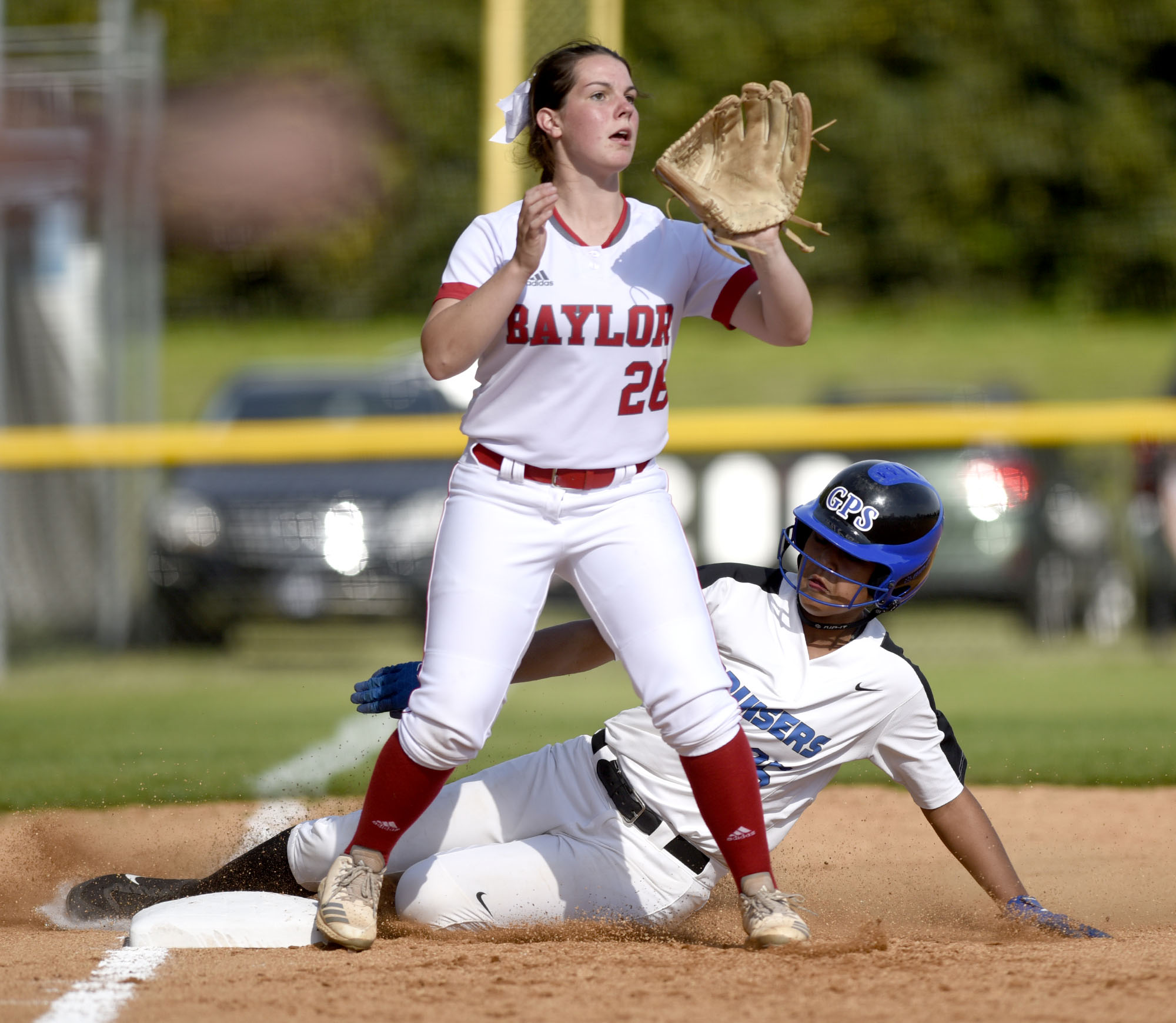 GPS's Ariana Whatley (25) slides safely into third while Baylor's Raven Jones (26) awaits the throw. The Baylor Lady Raiders visited the Girls Preparatory School Bruisers in TSSAA softball action. The Bruisers won 5 to 0.