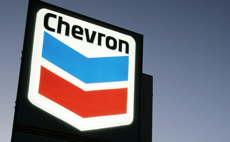 FILE - In this file photograph taken July 25, 2007, a Chevron gas station service sign is displayed in Menlo Park, Calif.  Chevron is buying Anadarko Petroleum in a cash-and-stock deal valued at $33 billion that’ll help strengthen its position in shale, deepwater and natural gas resource basins.  Chevron and Anadarko said Friday, April 12, 2019 that the deal will create a 75-mile-wide corridor across the most attractive acreage in the Delaware basin; bolster Chevron’s position in the Gulf of Mexico and add a resource base in Mozambique to support growing LNG demand. (AP Photo/Paul Sakuma, file)