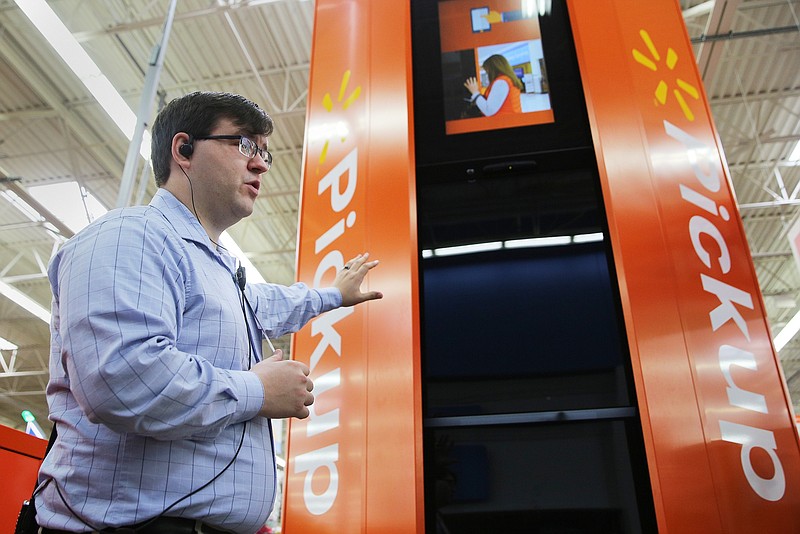 Neal Beeler, a store manager, describes how the new pickup tower at Walmart works on Wednesday, March 27, 2018 in Ooltewah, Tenn. With the pickup tower, shoppers get an email with a barcode, and they can walk up to the tower located at the front of the store, scan the barcode and the item automatically comes out. 