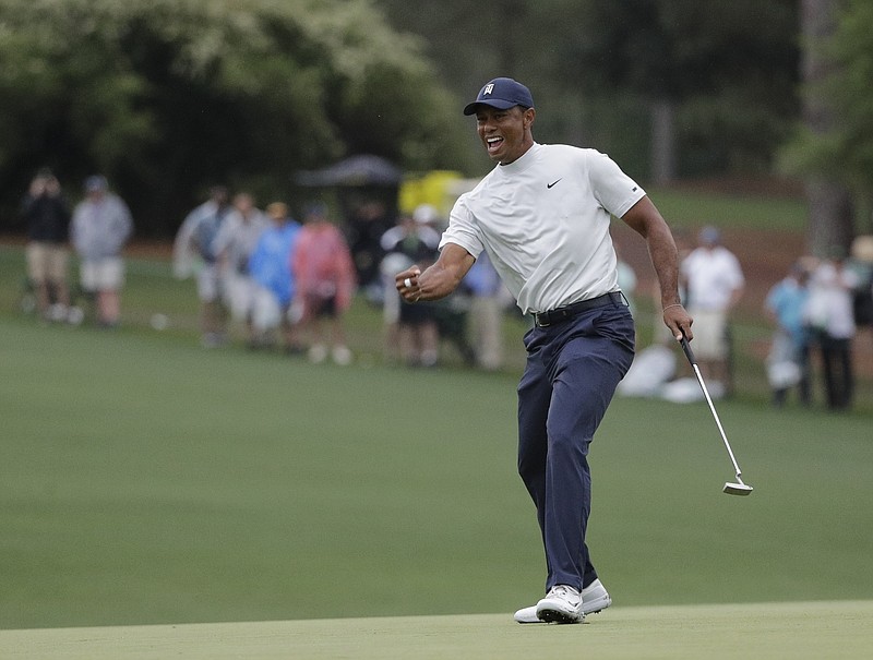 Tiger Woods reacts to his birdie putt on the 15th hole during the second round of the Masters on Friday at Augusta National Golf Club. Woods shot a 68 and was one stroke off the lead, though five golfers were tied for first.