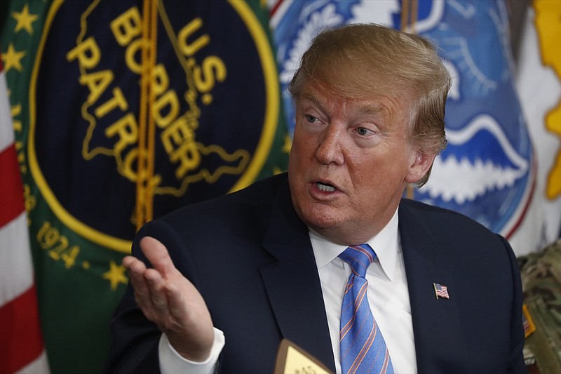 In this April 5, 2019, photo, President Donald Trump participates in a roundtable on immigration and border security at the U.S. Border Patrol Calexico Station in Calexico, Calif. Trump said Friday he is considering sending "Illegal Immigrants" to Democratic strongholds to punish them for inaction - just hours after White House and Homeland Security officials insisted the idea was dead on arrival. (AP Photo/Jacquelyn Martin)