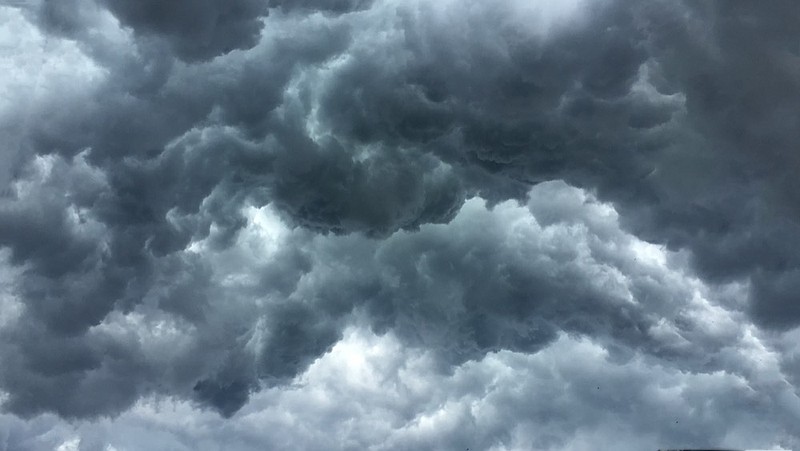 Over head Shot of rain cloud ; weather change storm tile rain clouds dark cloudy sky / Getty Images