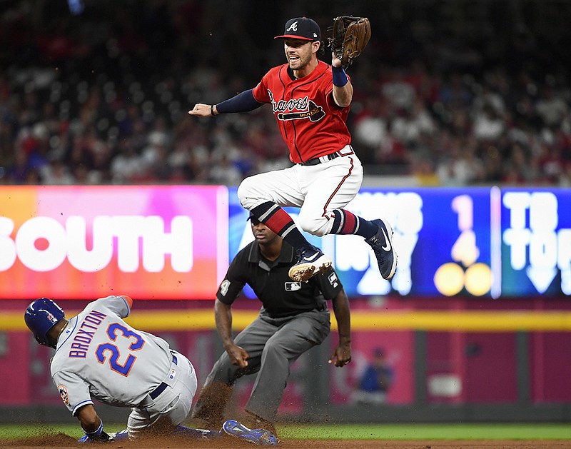 The New York Mets' Keon Broxton steals second base as Atlanta Braves shortstop Dansby Swanson goes high for the throw from catcher Tyler Flowers during the fourth inning of Friday night's game in Atlanta.