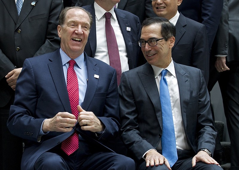 World Bank President David Malpas, left, speaks with Treasury Secretary Steven Mnuchin during a group photo of the G20 Finance Minister and Central Bank Governors at the World Bank/IMF Spring Meetings in Washington, Friday, April 12, 2019. (AP Photo/Jose Luis Magana)

