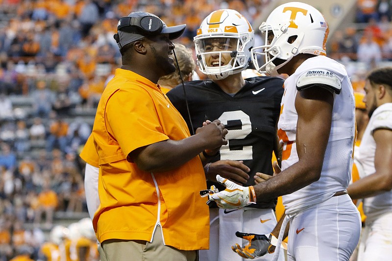 Tennessee assistant coach Tee Martin talks with quarterback Jarrett Guarantano (2) and receiver Jauan Jennings during the Orange and White spring football game Saturday at Neyland Stadium. Martin, a former Vols quarterback, joined the staff in the offseason.