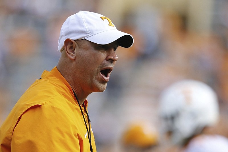 Tennessee football coach Jeremy Pruitt shouts as the Vols warm up for the Orange and White spring game Saturday at Neyland Stadium.