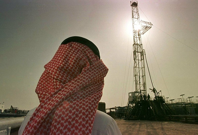 FILE - In this Feb. 26, 1997 file photo, Khaled al-Otaiby, an official of the Saudi oil company Aramco, watches progress at a rig at the al-Howta oil field near Howta, Saudi Arabia. According to an assessment published Monday, April 1, 2019, by Moody's Investors Services, the net profits of Saudi Aramco reached $111 billion last year. That places Aramco ahead of some of the world's most profitable firms. In their first-ever grade assessment for Aramco, Fitch Ratings issued the firm an A+ rating, while Moody's gave it it's A1 rating ahead of its upcoming bonds sale. (AP Photo/John Moore, File)

