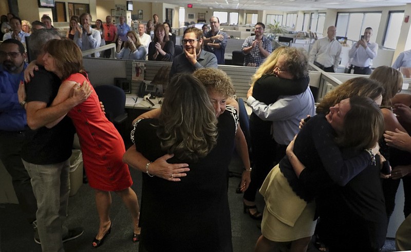 Staff of the South Florida Sun Sentinel celebrate their bittersweet honor Monday, April 15, 2019, in Deerfield Beach, Fla., after winning the Pulitzer Prize for Public Service. The newspaper won for its coverage of the Parkland school shooting. (Carline Jean/South Florida Sun-Sentinel via AP)

