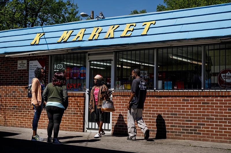 Staff photo by Doug Strickland / 
People enter K Market on Dodson Avenue on Tuesday, April 16, 2019, in Chattanooga, Tenn. A fatal shooting occurred outside the store Monday evening.