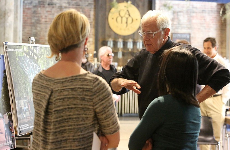 Former Chattanooga Mayor Ron Littlefield speaks with Katelyn Kirnie, director of public art for the City of Chattanooga, and Kat Wright, the public art coordinator, during the unveiling of the Patten Parkway redesign at The Camp House Monday night.
